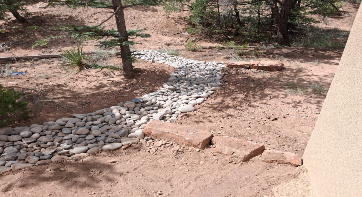 Landscape Drainage Solution: Decorative River Rock Channel
