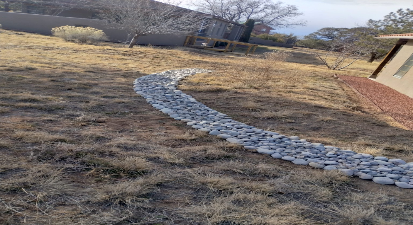 Landscape Drainage Solution: Decorative River Rock Channel
